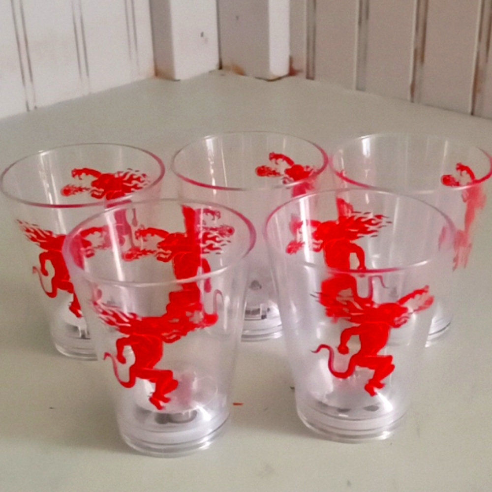 Five collectable shot cups, made of plastic with the fireball whisky symbol.